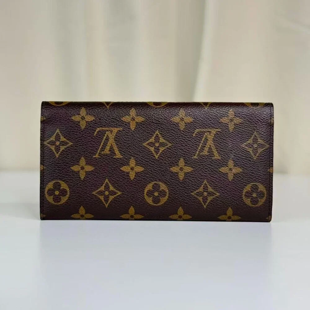Louis Vuitton Monogram Canvas Wallet with Classic Design and Red Pin Detail